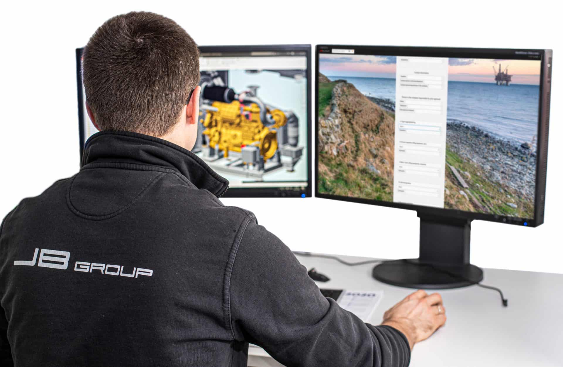 men working on computer with two screens